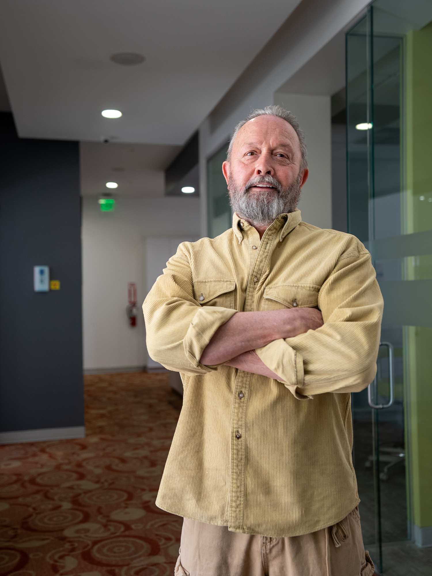full mouth reconstruction patient, Tony smiling n hallway of the practice